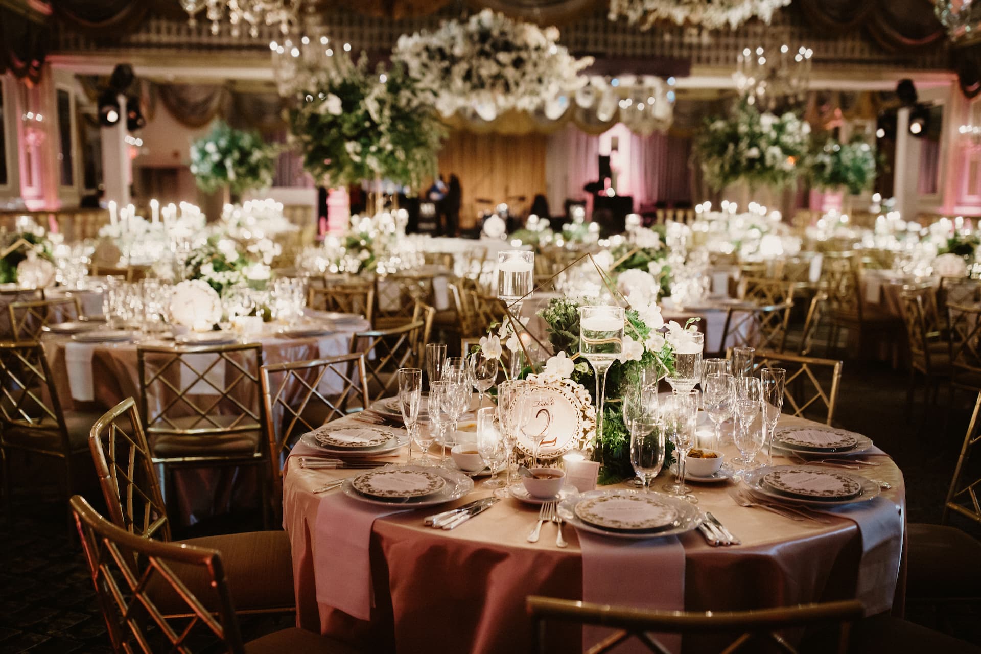 A table set and decorated for guests in a restaurant tent, chairs and tables in a party